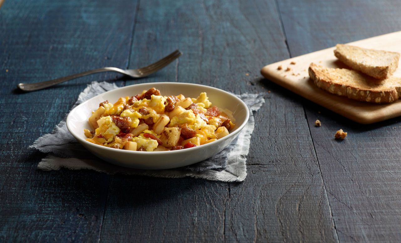 Jimmy Dean met lovers bowl with cut piece of bread on a cutting board